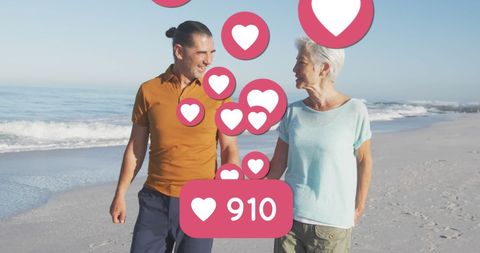 senior couple receiving social media engagement notifications on beach - Download Free Stock Images Pikwizard.com