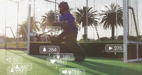 Teen Goalkeeper on Field Handling Hockey Stick with Overlayed Social Media Icons