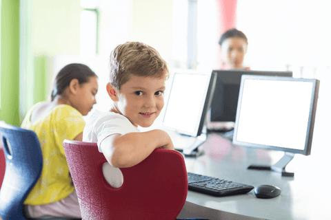 portrait of smiling boy in classroom with transparent computers - Download Free Stock Videos Pikwizard.com