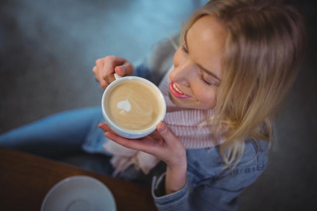 Smiling Woman Enjoying Coffee with Heart Latte Art - Download Free Stock Photos Pikwizard.com