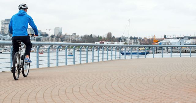 Cyclist Riding on Waterfront Path in Urban Area - Download Free Stock Images Pikwizard.com