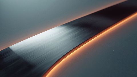 Futuristic curved metal strip with orange accent lighting