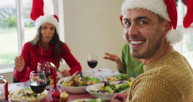 Friends Enjoying Christmas Dinner Together, Celebrating Holiday Season Indoors - Download Free Stock Images Pikwizard.com