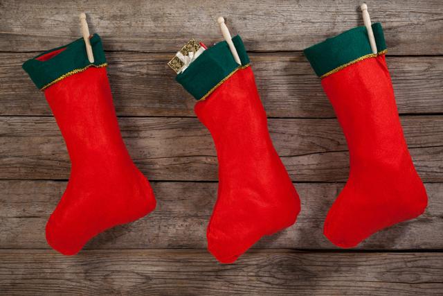 Christmas stocking hanging against wooden wall during christmas time