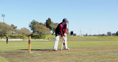 Cricket batsman ready to face bowler on cricket field