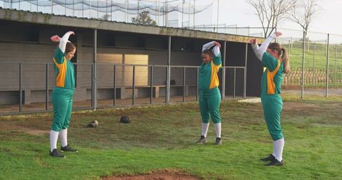 Female softball players warming up before game