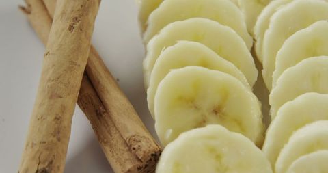 Close-Up of Sliced Bananas with Cinnamon Sticks - Download Free Stock Images Pikwizard.com