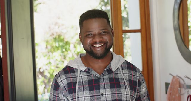 Smiling African American Man in Plaid Shirt at Home - Download Free Stock Images Pikwizard.com