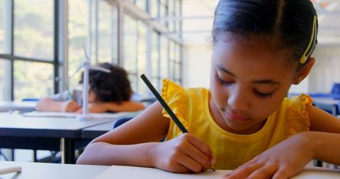 Focused Schoolgirl Studying in Bright Classroom - Download Free Stock Images Pikwizard.com