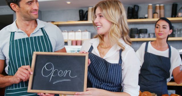 Café Employees Holding Open Sign and Smiling - Download Free Stock Images Pikwizard.com