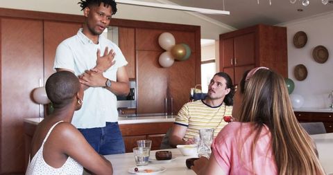 Diverse Friends Enjoying Home Lunch Gathering