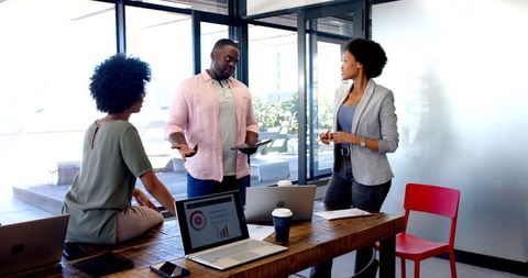 African American Professionals Engaging in Office Discussion, Collaborative Work Environment