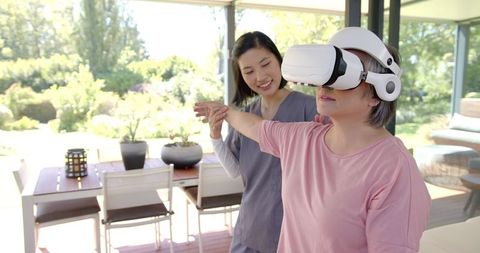 Senior woman using vr headset for physical therapy at home