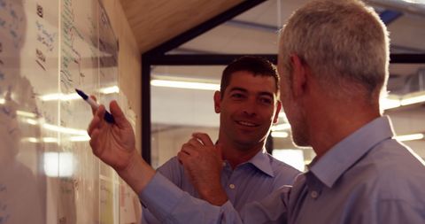 Business Colleagues Strategizing at Whiteboard Collaboratively