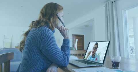 Woman Video Conferencing from Home Office with Laptop