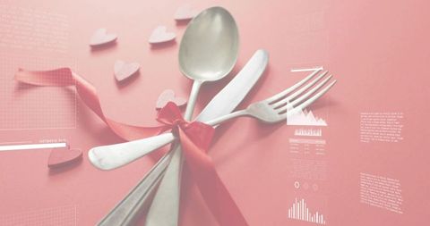 Romantic Cutlery Gift Tied with Red Satin Ribbon on Pink Background with Heart Confetti