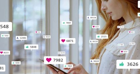 Woman checking smartphone with floating social media notifications in coworking space