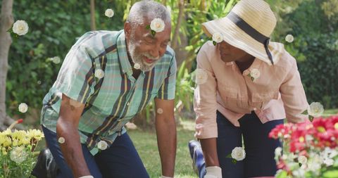 Joyful African American Father and Daughter Gardening Together
