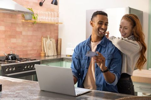 Couple Enjoying Digital Devices in Cozy Kitchen Setting
