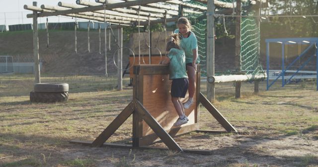 Sisters Climbing on Obstacle Course in Outdoor Adventure Park - Download Free Stock Images Pikwizard.com