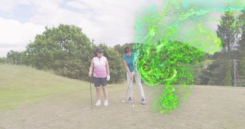 Senior golfer receiving swing instruction on fairway with friend and green swirl effect