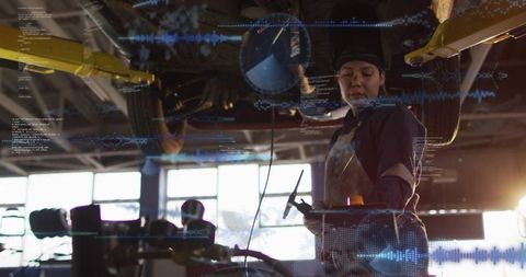 Female mechanic inspecting lifted car with diagnostic probe and augmented reality overlay