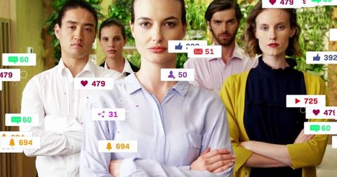 Leading team standing with crossed arms in modern green office with social media alerts