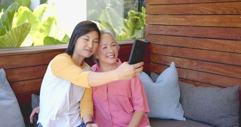 Women Enjoying Friendship and Bonding Time with Smartphone