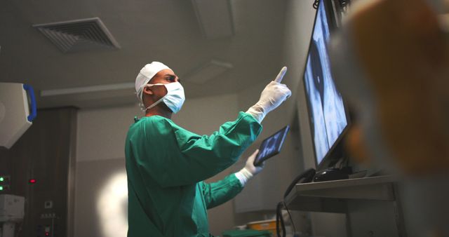 Surgeon Examining Medical X-Rays on Monitor in Surgical Room - Download Free Stock Images Pikwizard.com