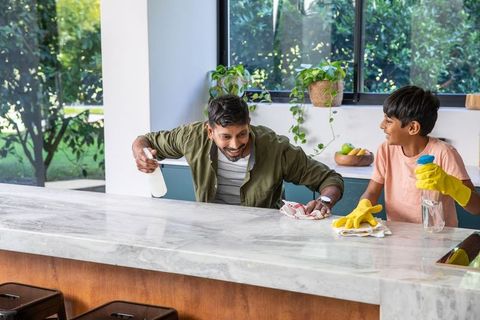 Father and Son Cleaning Modern Kitchen Together