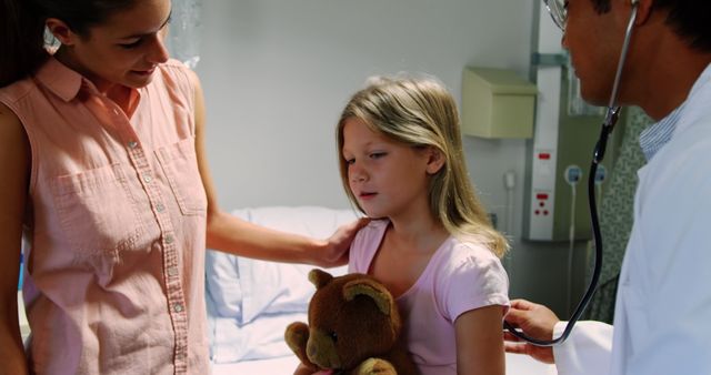 Mother comforting daughter during doctor's examination in hospital room - Download Free Stock Images Pikwizard.com