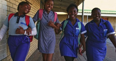 Joyful African American Girls in School Uniforms Walking Together