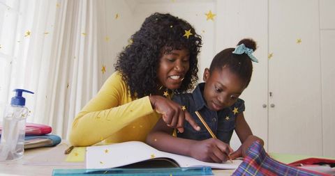 Engaged mother helping daughter with homework in cozy home