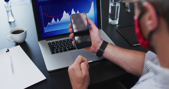 Businessman Analyzing Financial Graph and Data on Laptop and Smartphone - Download Free Stock Images Pikwizard.com