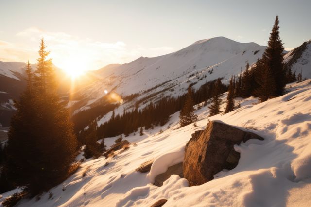 Beautiful sunrise casting warm light over snow-covered mountain and pine trees. Perfect for use in travel brochures, nature magazines, winter holiday promotions, or inspirational posters depicting natural beauty and serenity. Ideal for promoting outdoors activities like hiking and skiing.