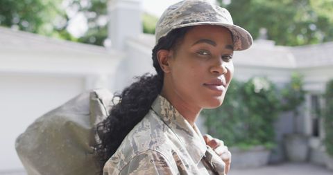 African American Female Soldier Carrying Backpack Outdoors