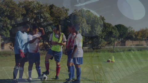 Female Football Players Analyzing Sports Data on Pitch