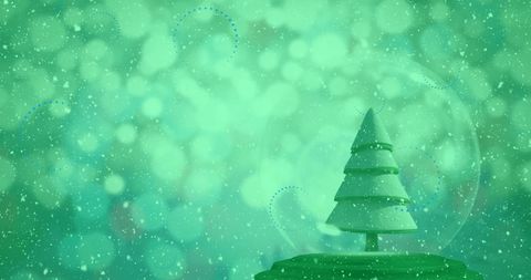 Christmas tree in snow globe with falling snow on green background