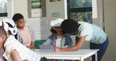 African american students exploring virtual reality headset in classroom stem activity