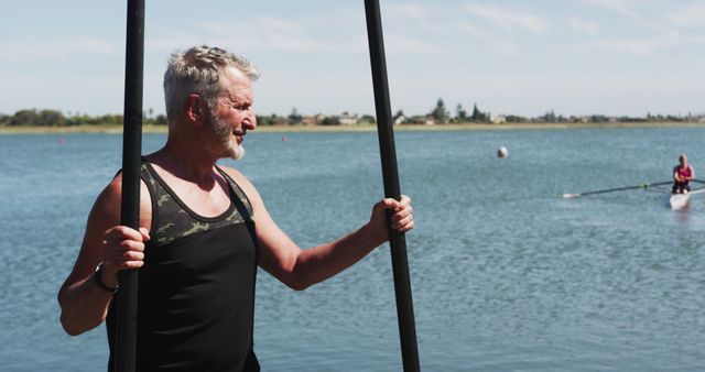 Active Senior Man Paddling Canoe on Calm Lake - Download Free Stock Images Pikwizard.com