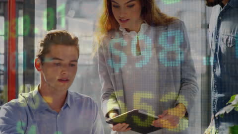 Collaborative Business Team Analyzing Digital Market Data in Modern Office