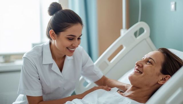 Female nurse comforting patient in hospital bed showing compassion and bedside care
