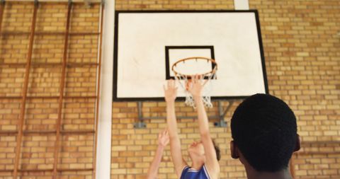 High School Students Playing Competitive Basketball Game in Gym