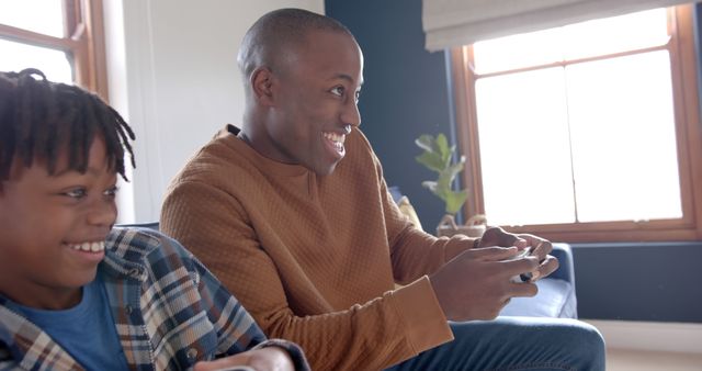 Father and Son Enjoying Quality Time Playing Video Games Together - Download Free Stock Images Pikwizard.com