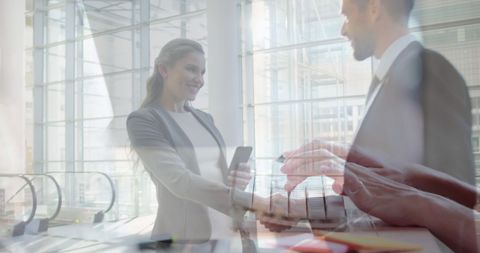 Businesswoman Shaking Hands with Colleague in Futuristic Office
