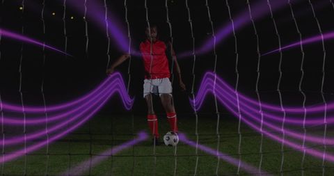 Dynamic soccer player with light trails creating futuristic energy