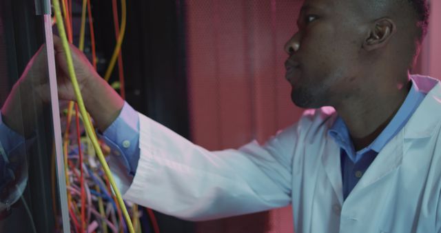 African American IT Technician Configuring Server Cables in Data Center - Download Free Stock Images Pikwizard.com