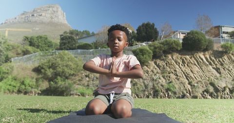 Young Boy Practicing Yoga and Meditation Outdoors