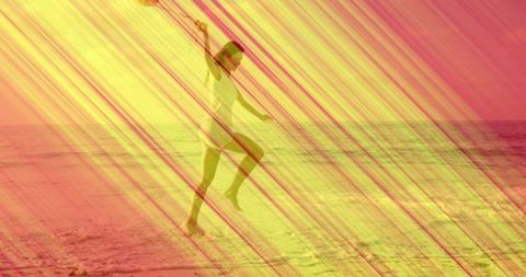 Woman balancing on beach at sunset lifting knee and raising arm with vibrant overlay