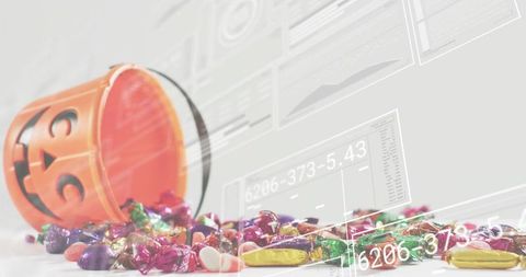 Tipping Jack-O-Lantern Bucket Spilling Assorted Halloween Candy with Futuristic Digital Overlays